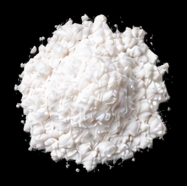A soft mound of white pantothenic acid powder